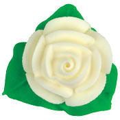 White royal icing rose cake decoration with layered petals and three bright green leaves, isolated on a white background.