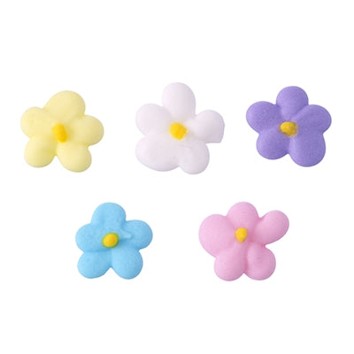 Close-up of delicate royal icing flowers in white, blue, pink, yellow, and purple, with yellow centers.