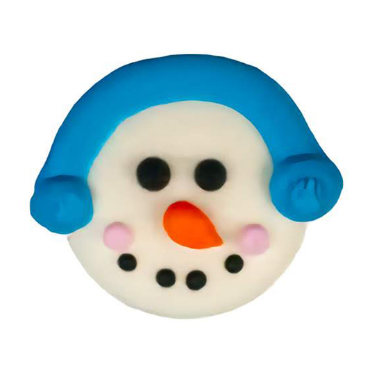 Edible royal icing snowman face decoration with blue winter hat, orange carrot nose, pink cheeks, and black dotted eyes and smile, 1 inch wide.