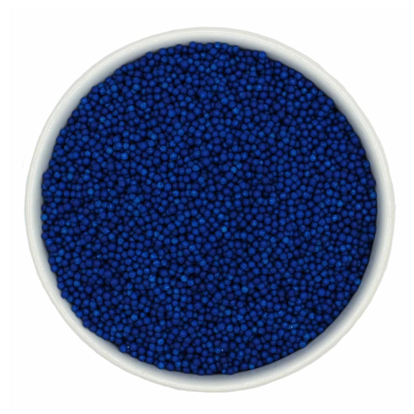 Top-down view of a white bowl filled with royal blue non-pareils, showing tiny round sprinkle beads in a deep vivid blue shade.