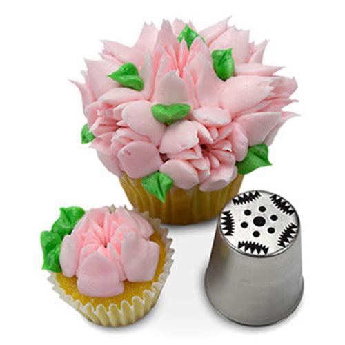 A cupcake and mini cupcake decorated with pink buttercream petals and green leaves, alongside a specialized Russian piping tip with a serrated edge, designed for creating realistic flower designs.