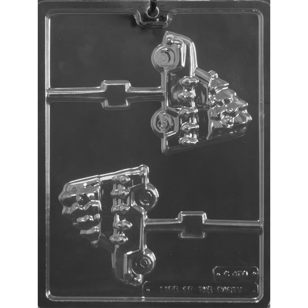 Clear chocolate lollipop mold with two SUV-shaped cavities, each carrying a Christmas tree on the roof and connected to a stick channel, shown on a dark background.