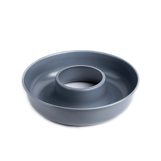 Gray circular cake pan with a central indentation on a white background