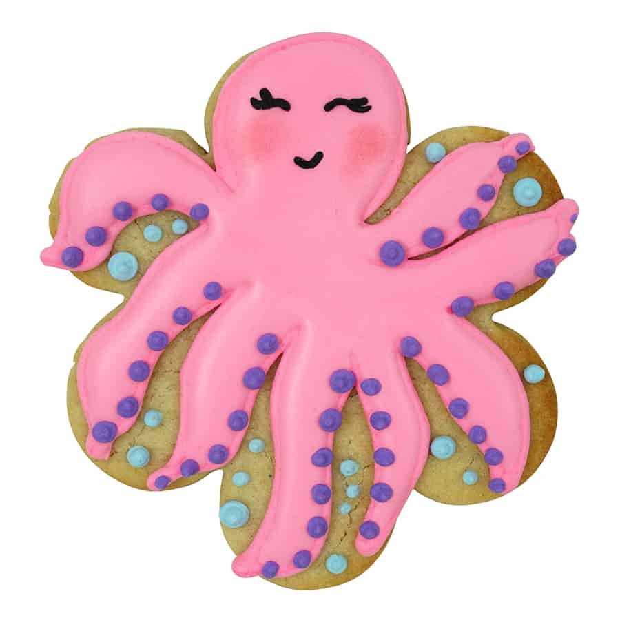 Scalloped cookie decorated as a pink octopus with playful icing details and purple dot accents.