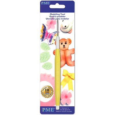 Scriber Needle Tool in retail packaging with sugarcraft decorations including flowers, a bear, and butterflies