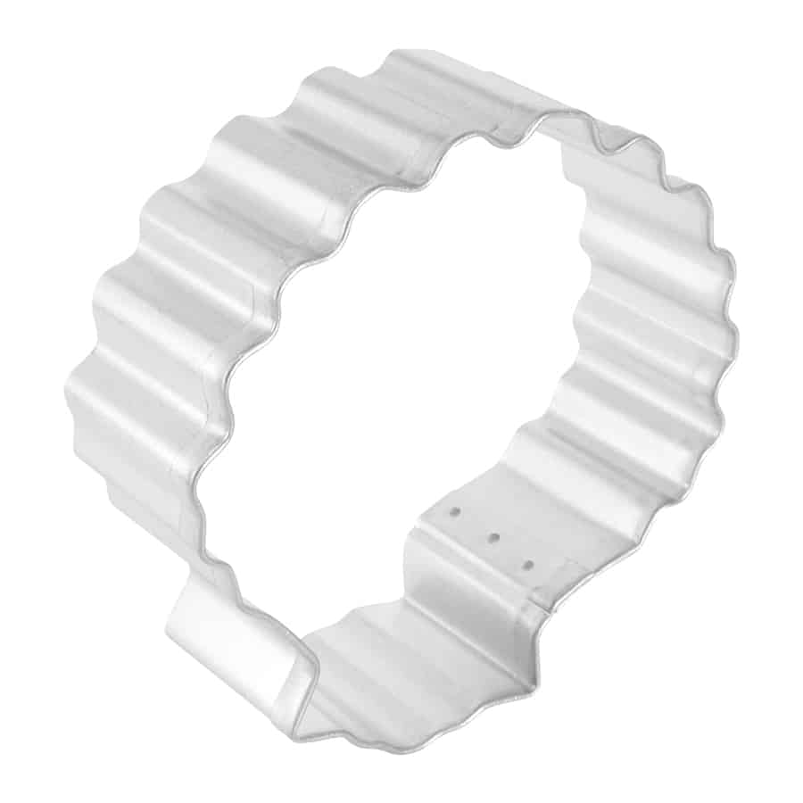 Side view of a tinplated steel sea shell cookie cutter with ridged edges.