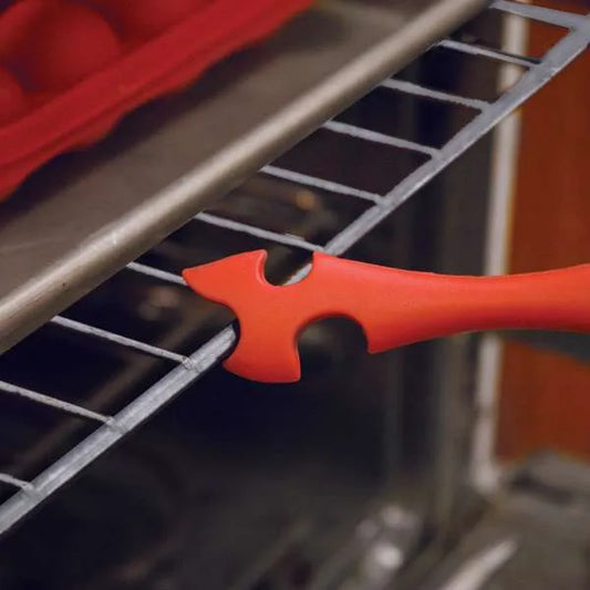 Silicone oven rack tool in use, pushing a hot oven rack forward for safe and convenient baking.