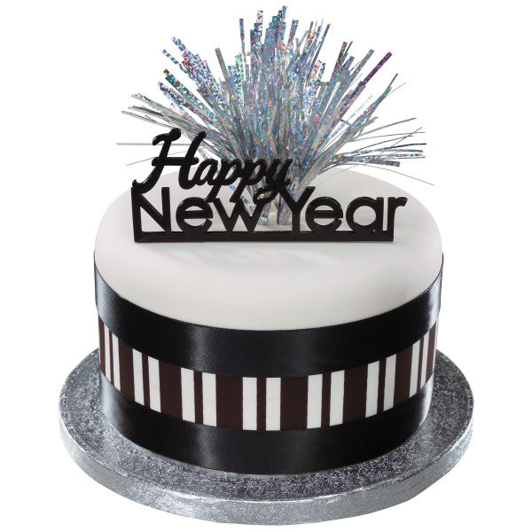 White cake with striped black ribbon and “Happy New Year” topper, accented with silver mylar pick