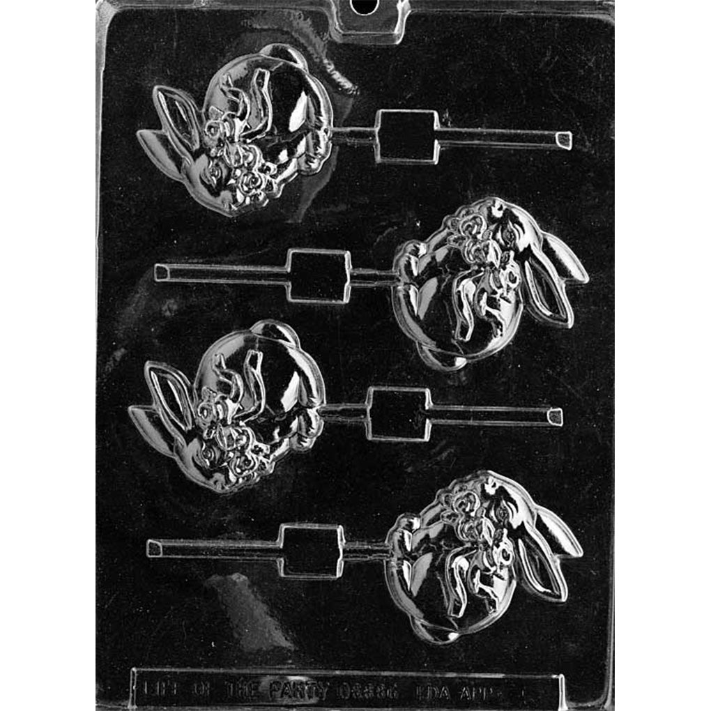 Clear plastic chocolate lollipop mold with four cavities shaped like a seated bunny wearing a bow, each cavity paired with a stick channel on a dark background.