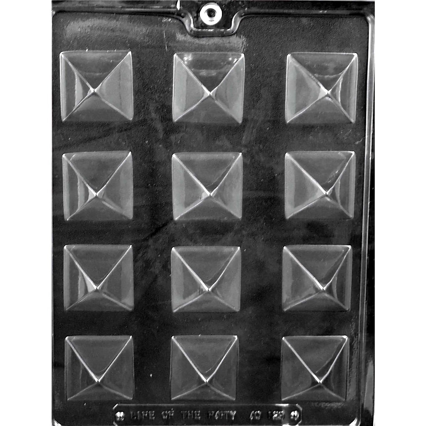 Clear plastic chocolate mold designed for creating small pyramid-shaped chocolates, featuring twelve compartments arranged in three rows of four. Each compartment is shaped like an inverted pyramid with sharp, defined edges, enhancing the three-dimensional effect. The mold is set against a black background to highlight the geometric precision of each pyramid. 