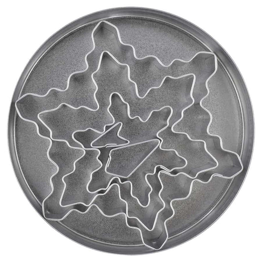 Nested snowflake cookie cutter set displayed inside a round tin container.
