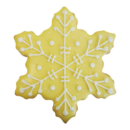 Yellow snowflake cookie with white piped royal icing snowflake pattern and decorative dots.