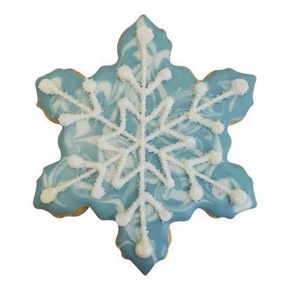 Decorated snowflake-shaped cookie with a marbled blue background and white icing details.