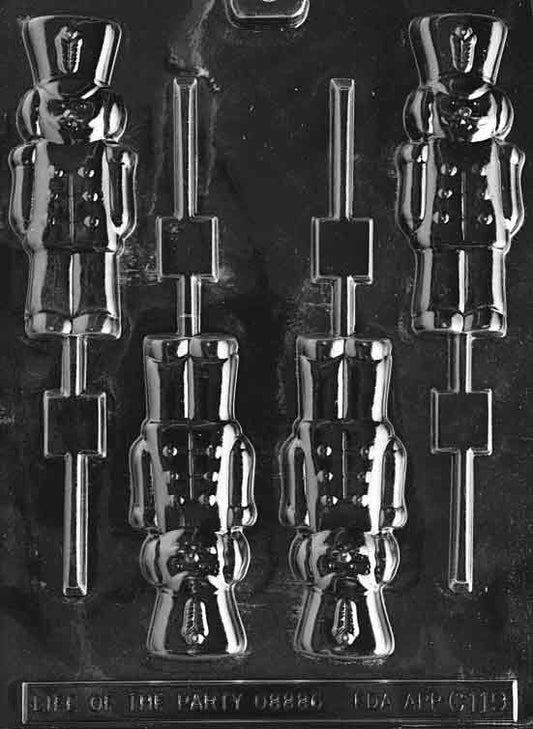 Clear plastic chocolate mold with four vertical cavities shaped like classic toy soldier lollipops, each featuring detailed military uniforms and tall hats, ideal for making holiday-themed chocolate pops.