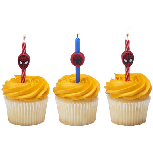 Three cupcakes topped with Spider-Man birthday candles featuring red and blue swirls and Spidey-themed toppers.