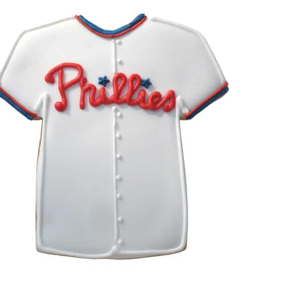 Decorated sports jersey cookie with a Phillies theme, featuring white icing and red details.