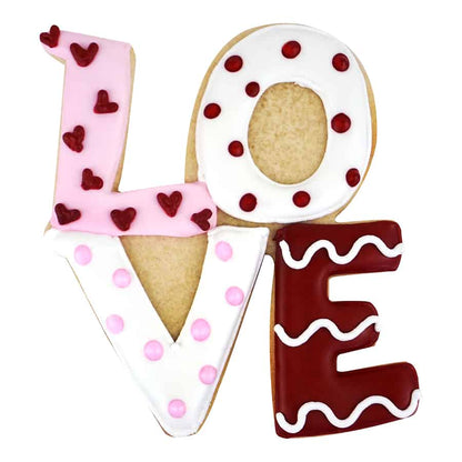 Decorated Love cookies with each letter uniquely styled in red, white, and pink icing, featuring hearts, polka dots, and swirls.