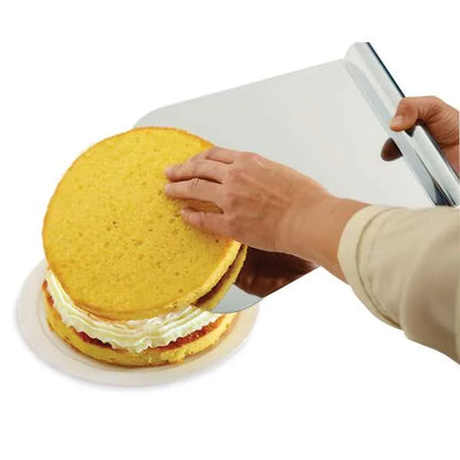 Mega lifter being used to transfer a cake layer with filling, illustrating its utility in cake assembly.