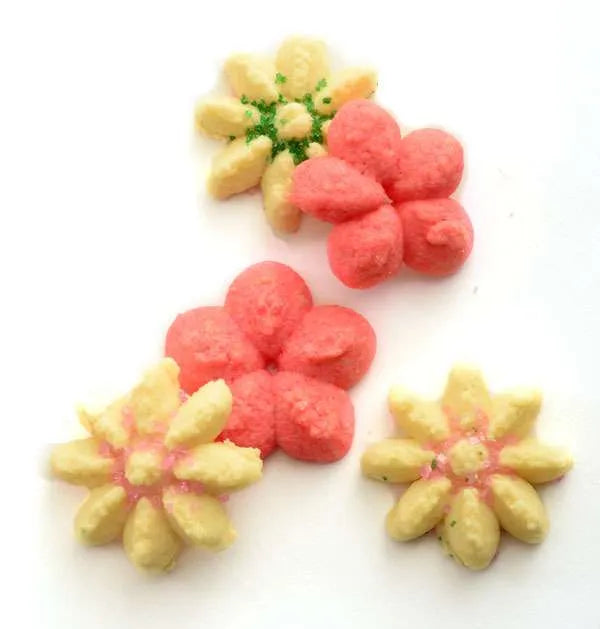 Assortment of colorful flower-shaped cookies made with press discs.