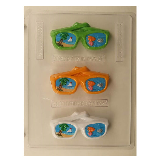 Chocolate mold featuring sunglasses with tropical scene insets, ideal for creating unique summer-themed confections or party favors.