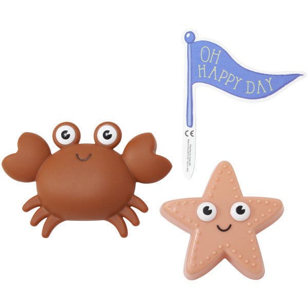 A crab and starfish bath toy with a blue "Oh Happy Day" flag.