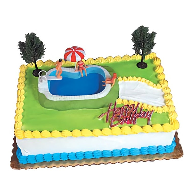Swimming pool cake decorating kit, featuring a pool with figurines enjoying water activities, complete with trees and a 'Happy Birthday' sign, ideal for summer-themed birthday cakes.