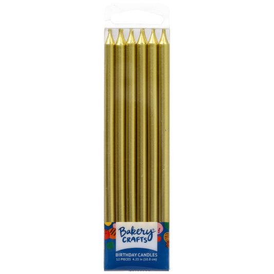 Clear plastic box of tall metallic gold birthday candles with pointed tips, labeled “Bakery Crafts,” showing multiple long candles aligned upright inside the package.