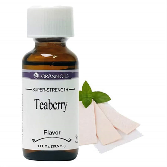 LorAnn Super Strength Teaberry Flavor, with the bottle next to a leaf of mint and teaberry gum pieces, suggesting its use for unique candy creations.