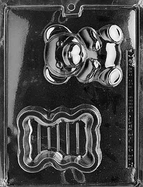 Plastic candy mold with two cavities: one shaped like a teddy bear with detailed face and paws, and one shaped like the base of a box with ridged edges, designed for making a hollow chocolate pour box.