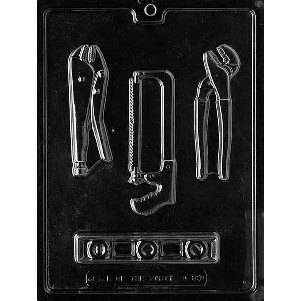 Clear plastic chocolate mold with tool shapes including pliers, a hacksaw, and a level.
