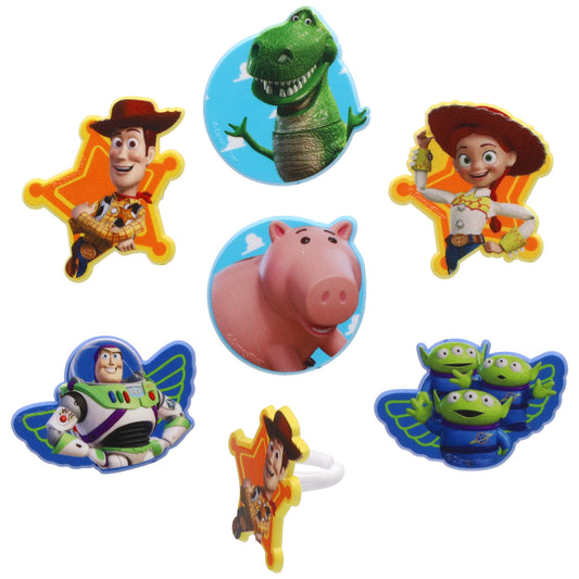 Assorted Toy Story cupcake rings showing character toppers including a cowboy, dinosaur, piggy bank, space ranger, and three green aliens on a white background.