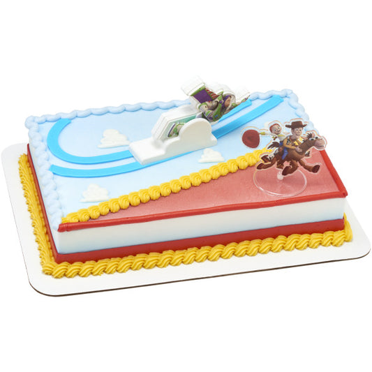 Rectangular Toy Story cake decorated in blue, red, and yellow with a Buzz Lightyear cloud topper and a Woody and Jessie standee on top.