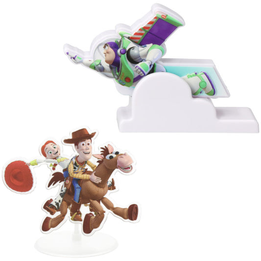 Toy Story cake kit with a Buzz Lightyear flying topper on a cloud base and a separate Woody and Jessie standee riding Bullseye on a white background.