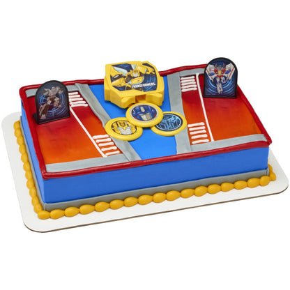 A rectangular cake decorated with the Transformers™ Autobot Battle DecoSet®, featuring a bold red and blue battle-ready design.