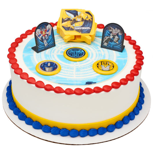 A round cake decorated with the Transformers™ Autobot Battle DecoSet®, showcasing a high-tech circuit board design and interactive elements.