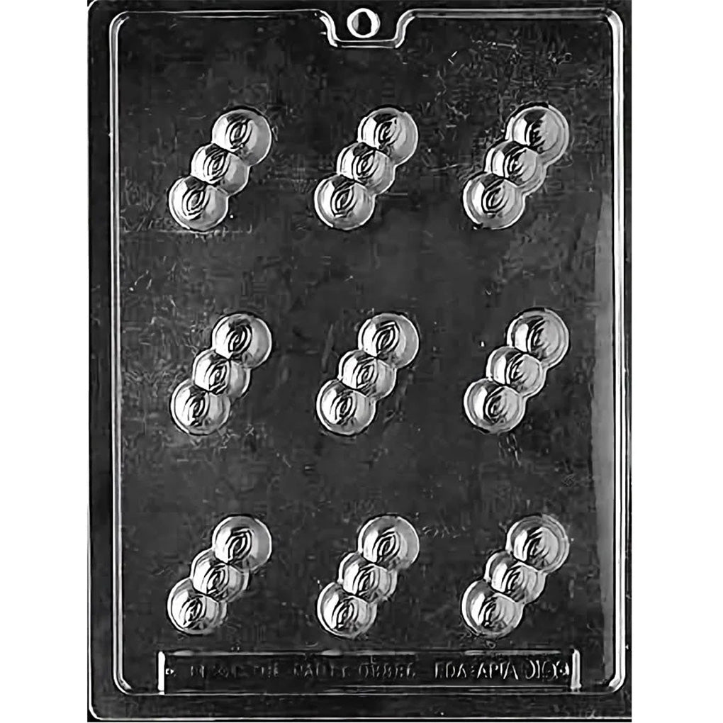 Clear plastic chocolate mold photographed on a dark background, showing nine cavities shaped like three connected round bumps with subtle curved ridge details.