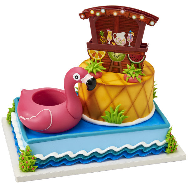 A rectangular cake decorated with the Pool Party Signature DecoSet®, designed to look like water with a pineapple island and tiki bar.