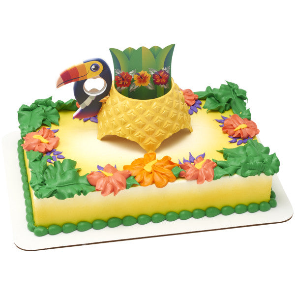 A rectangular cake decorated with the Tropical Vibes DecoSet®, surrounded by colorful icing flowers and greenery.