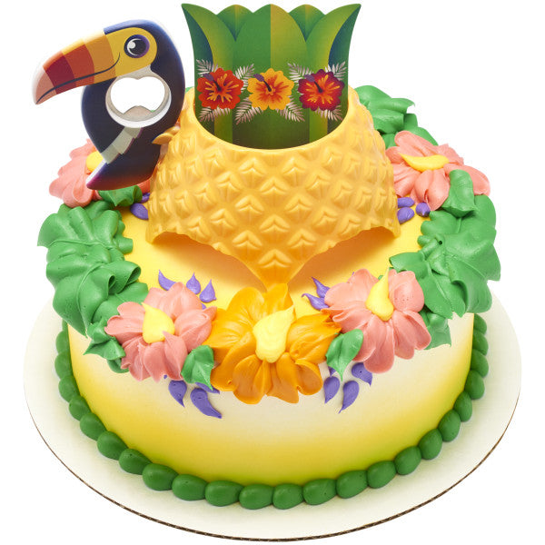 A round cake with the Tropical Vibes DecoSet® on top, featuring a pineapple drink holder and vibrant floral decorations.