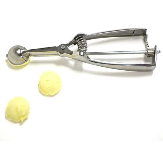 Truffle scoop shown with two uniform scoops of dough or filling on a white surface, demonstrating its size and portioning accuracy.
