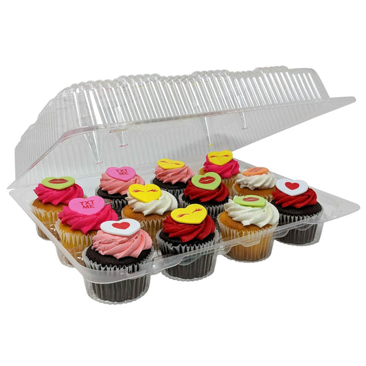 Clear hinged cupcake container holding 12 decorated cupcakes with pink, red, and white frosting swirls topped with heart and emoji-style decorations, shown partially open.