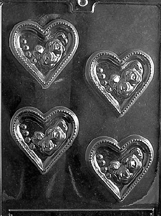 HEARTS WITH ROSES chocolate mold with cavities shaped like hearts decorated with roses; clear sheet.