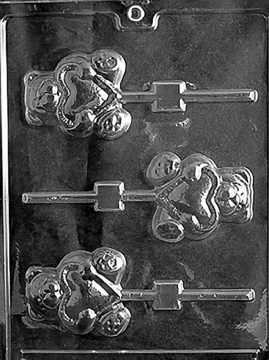 TEDDY WITH HEART Lollipop chocolate mold with teddy bear lollipop holding a heart; clear sheet.