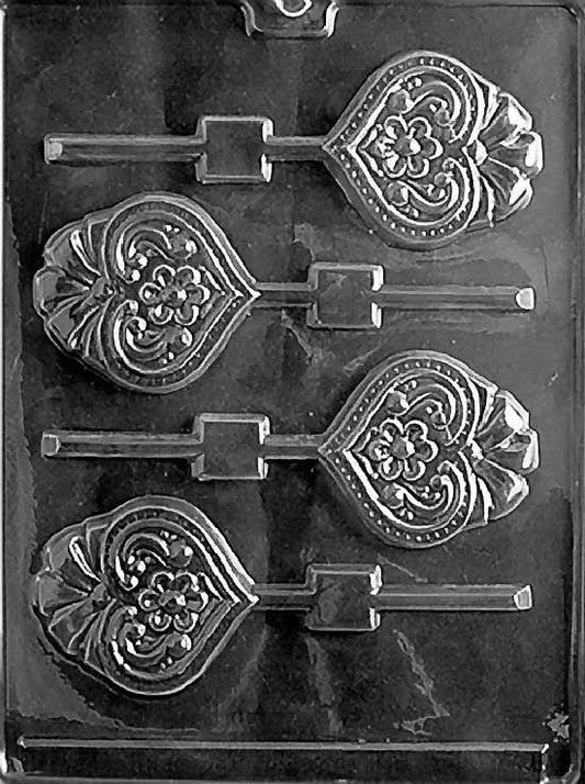HEART WITH BOW Lollipop chocolate mold with lollipop cavities featuring heart and bow design; clear sheet.