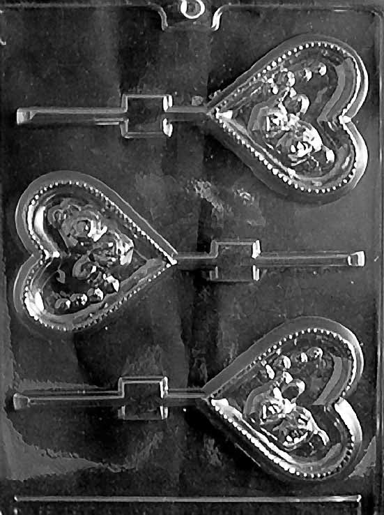 HEART WITH ROSES Lollipop chocolate mold with heart-shaped lollipop cavities decorated with roses; clear sheet.
