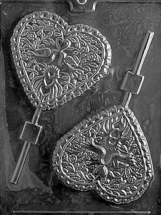 LARGE HEART WITH DOVES Lollipop chocolate mold with large heart lollipop cavities featuring doves; clear mold.