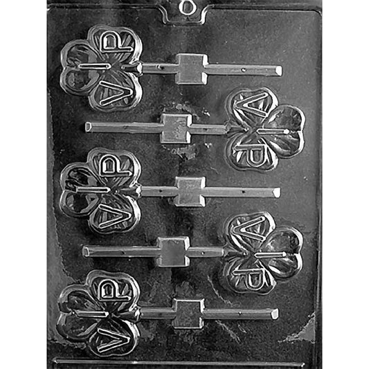 VIP shamrock chocolate lollipop mold with six shamrock-shaped cavities, each embossed with the letters “V.I.P.” and connected to lollipop stick channels, shown in clear plastic.