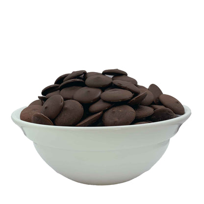 Overflowing white bowl of glossy Vegan and dairy free dark chocolate melting wafers isolated on a white background, suitable for gourmet baking and chocolate molding at Lynns' Cake and Candy Supplies.