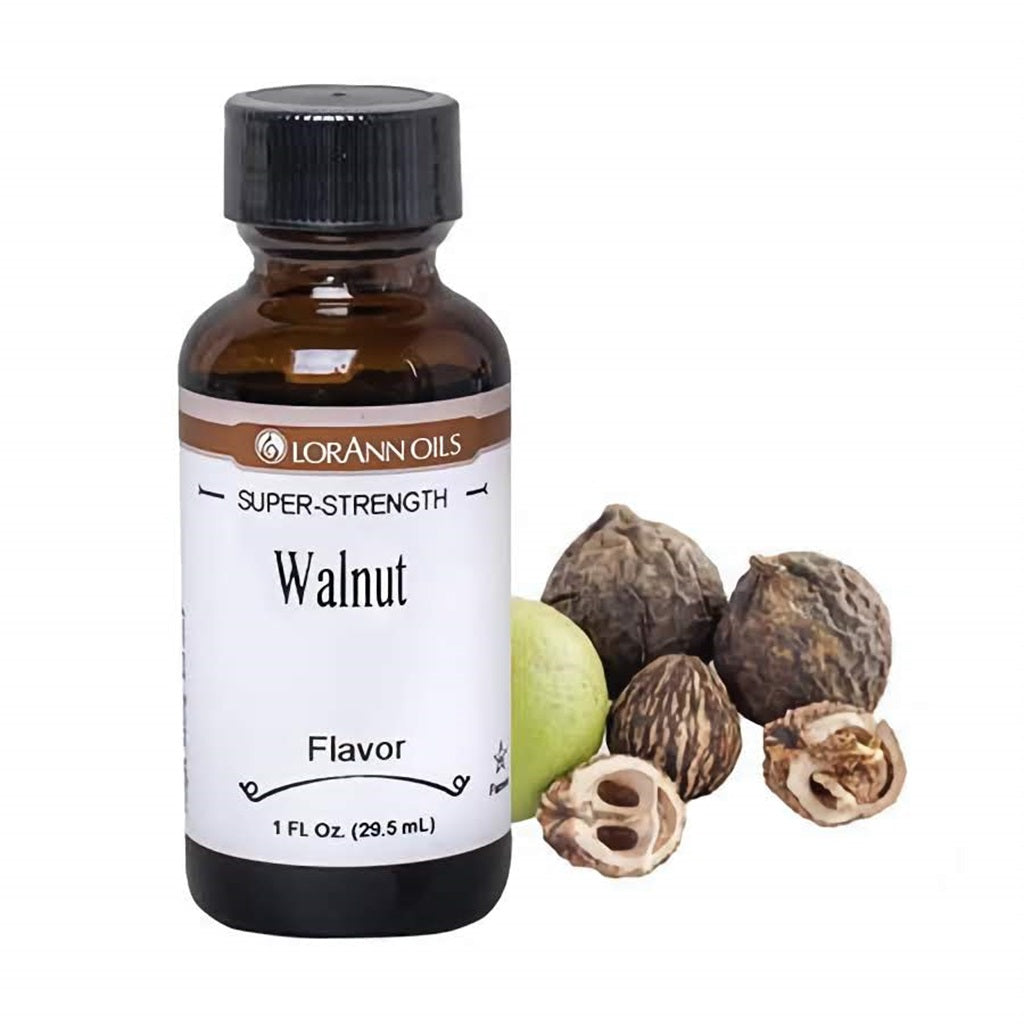 A bottle of LorAnn Super Strength Walnut Flavor next to shelled walnuts and a green walnut, perfect for imparting a nutty taste to baked goods.