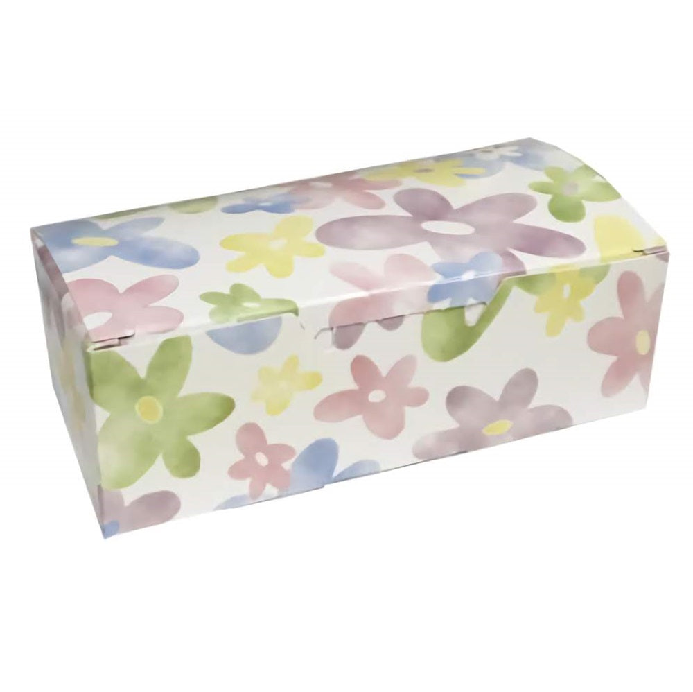 The image displays a rectangular candy box with a watercolor daisy design. The box has a soft pastel background with a pattern of simple, stylized daisies in light pink, blue, yellow, and green hues, giving it a gentle, springtime feel. 